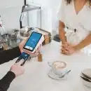 woman standing and holding smartphones