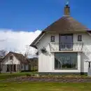 white concrete house on green grass field during daytime