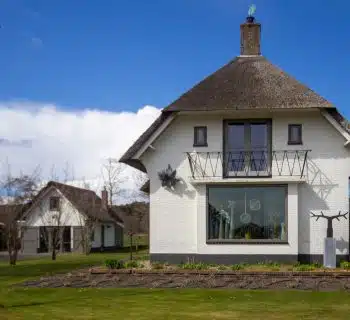 white concrete house on green grass field during daytime