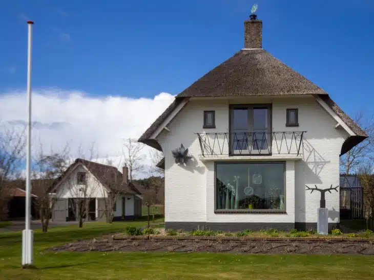 white concrete house on green grass field during daytime