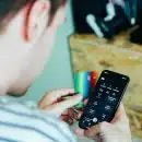 person holding black remote control